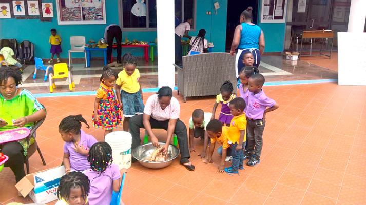 Some of the children observing how a fowl is slaughtered and chopped into pieces before the preparation of a meal. Some of the children observing how a fowl is slaughtered and chopped into pieces before the preparation of a meal.